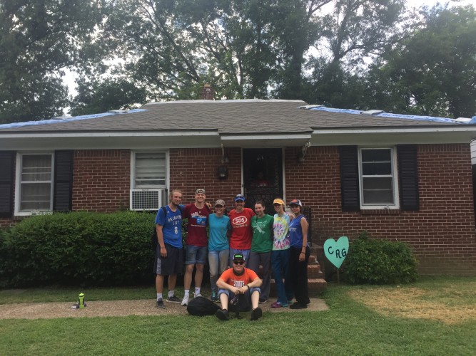 work crew standing in front of home