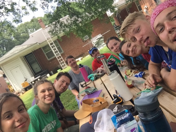 Youth sitting together at picnic table